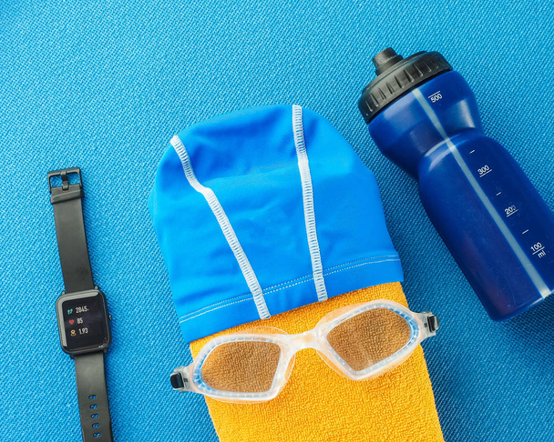 Flat lay composition with equipment for swimming pool  on blue background. Concept healthy lifestyle, sport and diet. Top view, text space.  - Φωτογραφία, εικόνα