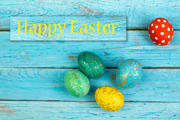 Happy Easter card. Colorful shiny easter eggs on wooden background. Copy space for text - Photo, image