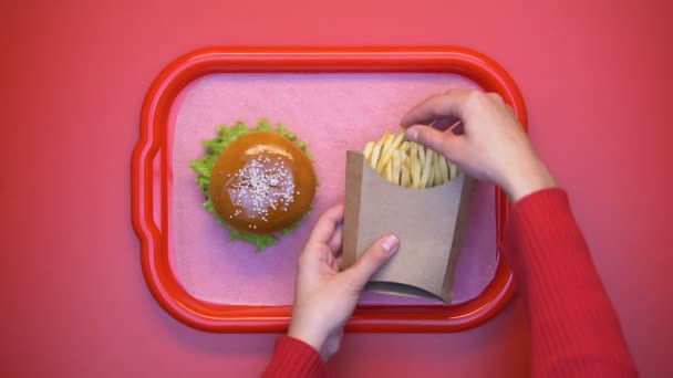 Buffet customer taking crispy french fries from carton package hands, fattening - Filmagem, Vídeo