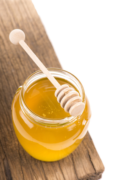 Honey in bank on wooden boards - Photo, Image
