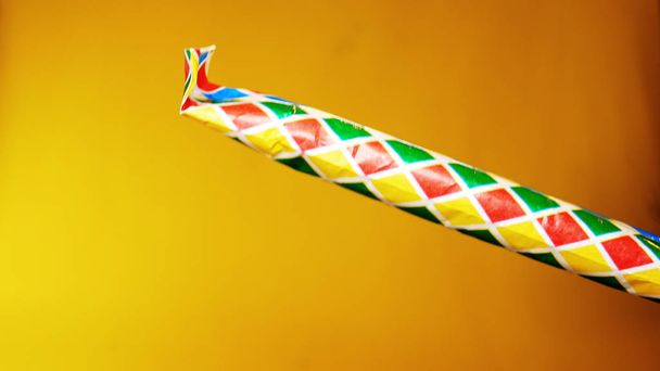 party horn is blown on yellow background, footage ideal for carnival period and for parties - Photo, Image