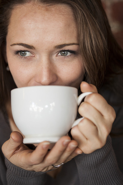 Young Woman with Beautiful Green Eyes with White Coffee Cup - Fotó, kép