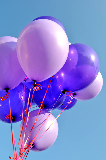 bunch of blue and violet balloons in the city festival,vertical composition - Foto, imagen