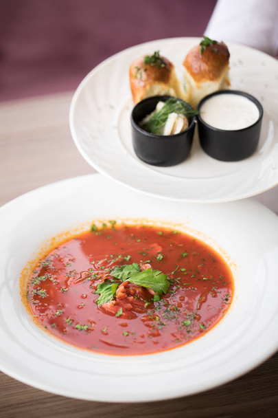 Traditional Ukrainian Russian borscht with beef on the bowl. Top view.Borscht with sour cream - 写真・画像