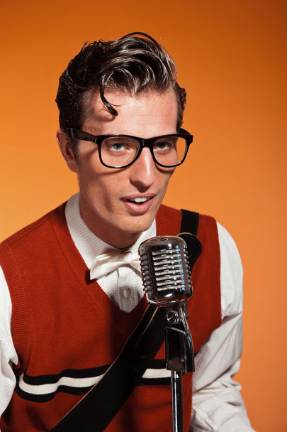 Retro fifties style rock and roll singer with vintage microphone - Fotó, kép