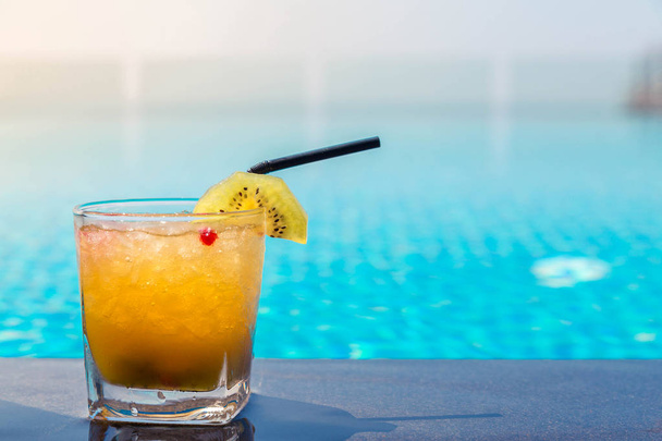 Photo of Yellow cocktail near the swimming pool - Photo, Image