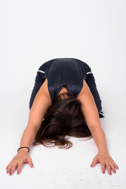 Full body shot of young Asian woman doing Child yoga pose - Valokuva, kuva