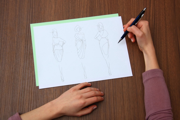 designer assessing fashion drawings - Foto, immagini
