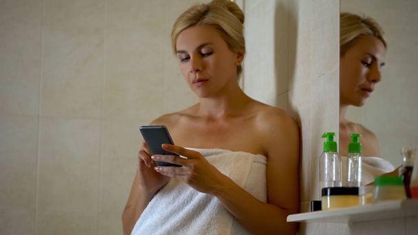 Workaholic woman using gadget in bathroom, no private life, business app - Φωτογραφία, εικόνα