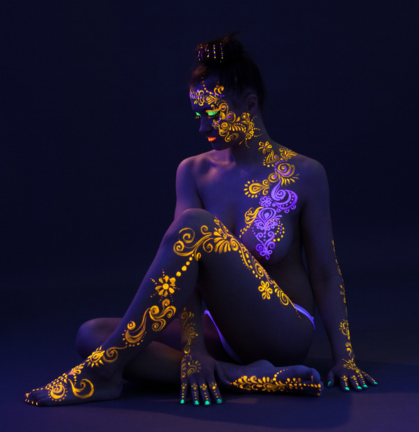 Graceful woman with glowing pattern on body - Фото, изображение
