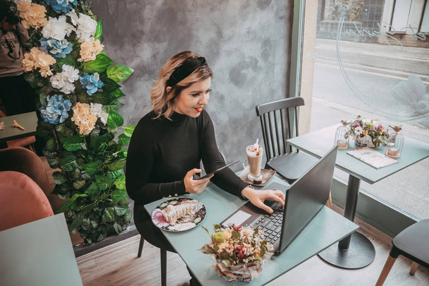 Girl typing on laptop and drink coffee - Фото, зображення
