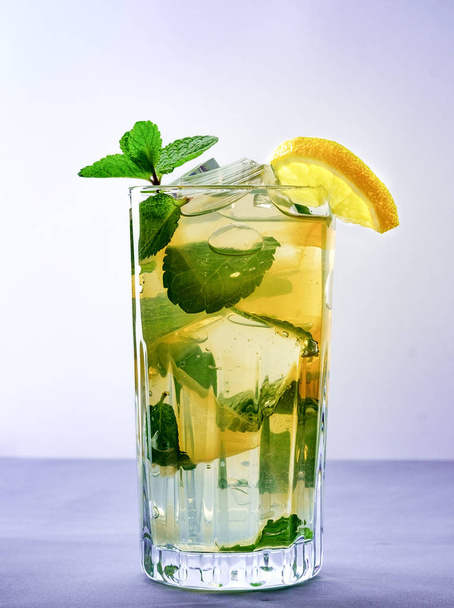 Cold refreshing summer lemonade in a glass on a grey background - Foto, imagen