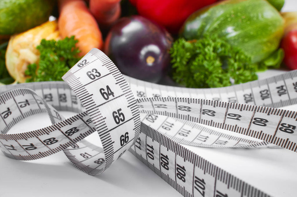 pile of fresh vegetables with measuring tape , healthy concept - Photo, Image