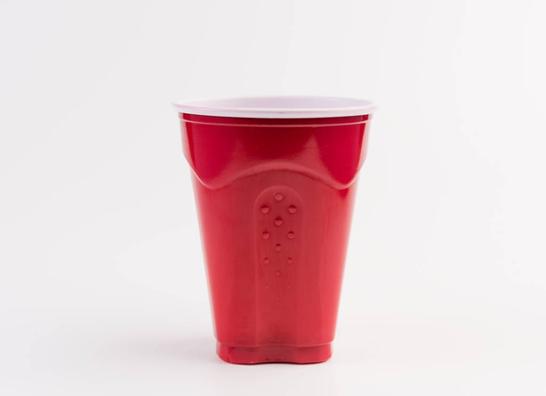 Empty red plastic cup isolated on white - Foto, Imagen