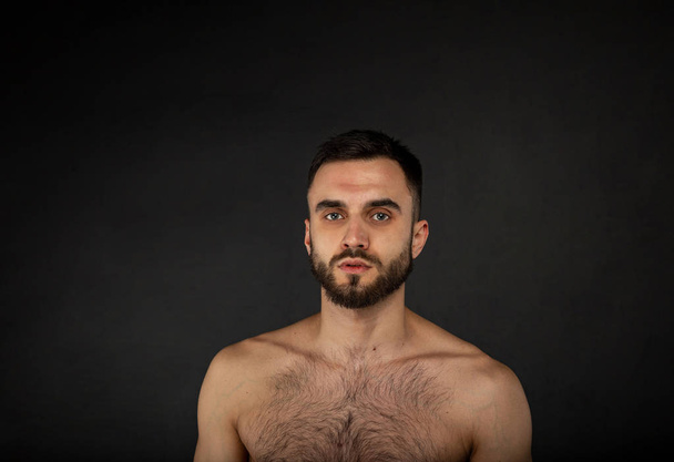 Young handsome bearded man or hipster guy with serious face and bare slim or thin body - Fotó, kép