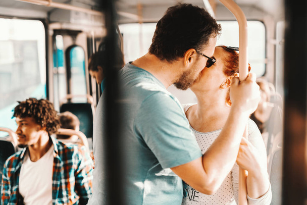 young adorable couple kissing in bus - Valokuva, kuva