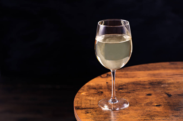Refreshing White Wine Glass on a Table - Foto, afbeelding