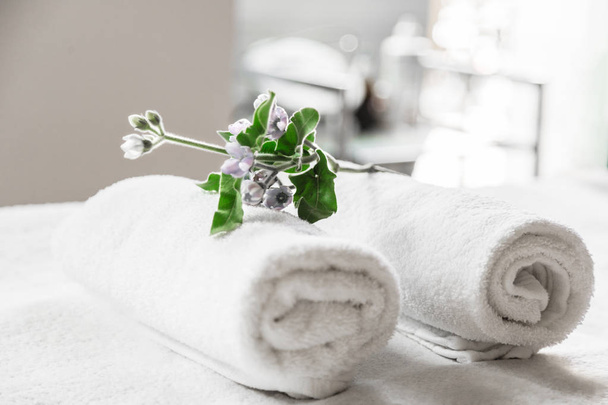 Towels and flower composition in beauty center - Photo, image