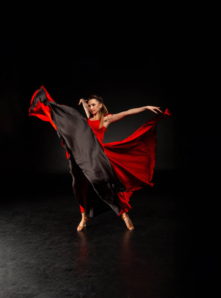 Graceful ballet dancer or classic ballerina dancing isolated on dark studio. - Фото, зображення