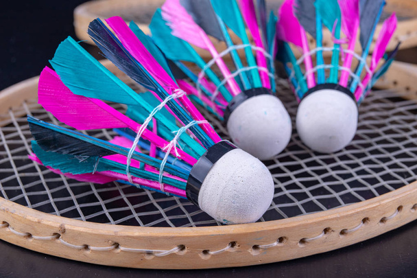 Colorful feathers in the badminton shuttlecock. Team play set. Dark background. - Fotó, kép