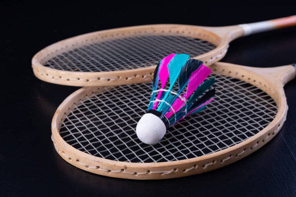 Colorful feathers in the badminton shuttlecock. Team play set. Dark background. - Fotó, kép