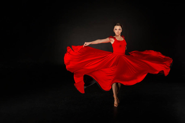 Young beautiful girl in red waving flying dress - Photo, Image