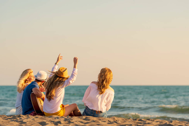 Group of friends enjoy on the beach - Фото, зображення