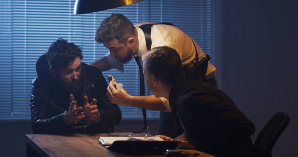 Policemen interrogating a drug dealer - Photo, Image