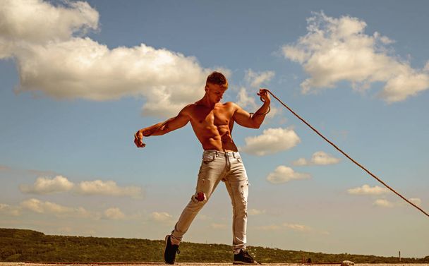 Ambition is the path to success. Athlete with fit sexy torso. Strong man pull rope. Sport man develop muscular hand strength. Sport exercises to build strength and power. Achieving ambition in sport - Фото, зображення