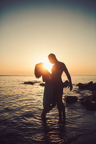 Romantický mladý pár na pláži, silueta. - Fotografie, Obrázek