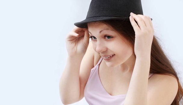 smiling young woman in black hat.isolated on a white - Foto, imagen