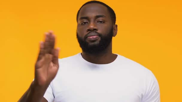 Confident Afro-American man showing stop sign male against racial discrimination - Felvétel, videó