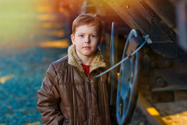 światło słoneczne chłopiec bezdomnych duży portret w brązowy płaszcz na ulicy r - Zdjęcie, obraz