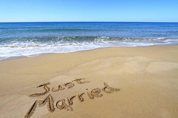 "Just married" written on golden sandy beach - Photo, image