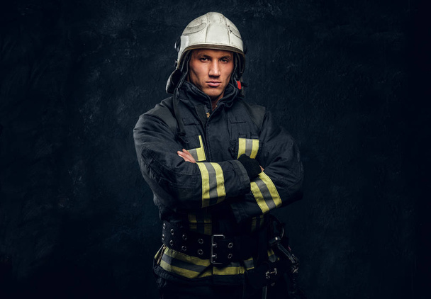 Manly firefighter in helmet looks into camera - Foto, immagini