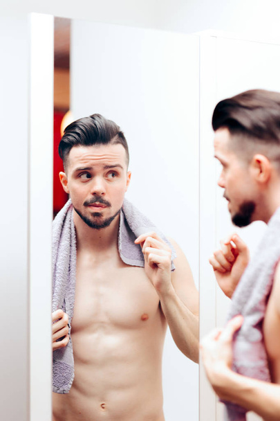Handsome Man Checking Himself in the Mirror - Фото, изображение