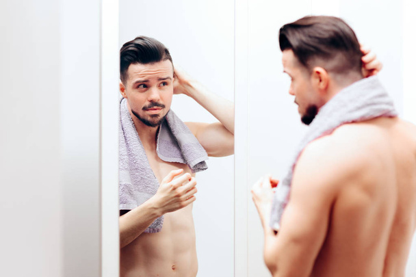Handsome Man Checking Himself in the Mirror - Foto, Imagen
