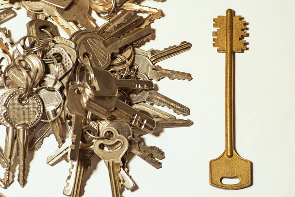 Many keys of different sizes. Keys on a white background, close-up. Selective focus, soft focus. - Photo, Image