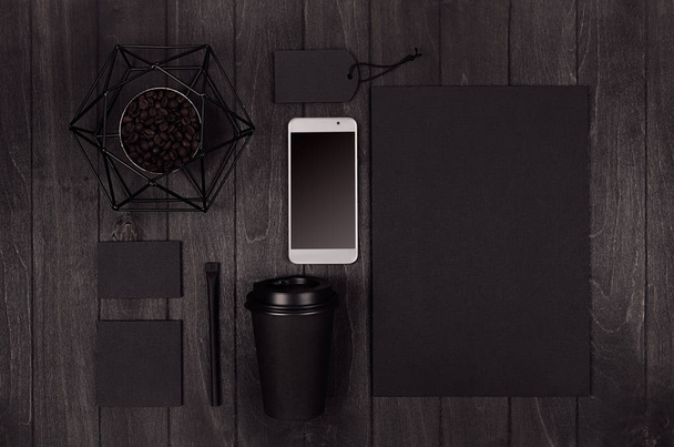 Eco friendly coffee template for design, advertising and branding - black paper cup, blank screen phone, label, card, decoration with coffee beans on dark wood board. - Fotografie, Obrázek