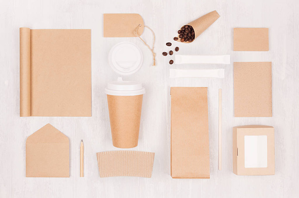 Coffee shop template for branding identity - brown paper cup, blank notebook, packet, label, card, box, stationery, coffee beans on white wood board. - Foto, Bild