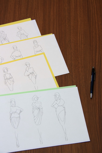 designer assessing fashion drawings - Photo, Image