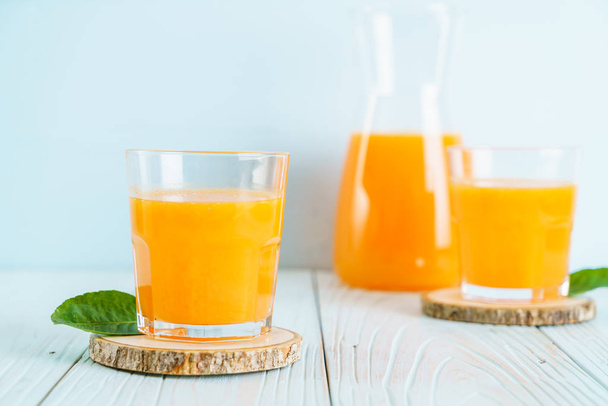 Fresh orange juice on wood background - healthy drink - Foto, Imagen