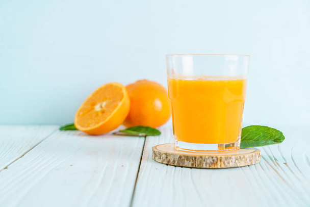 Fresh orange juice on wood background - healthy drink - Foto, imagen