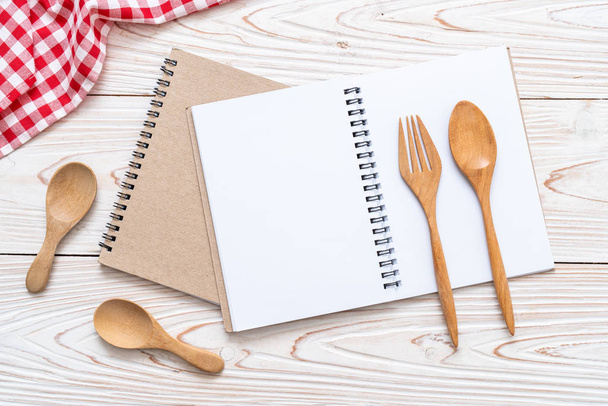 blank notebook for text note on wooden surface and wooden spoon and fork with copy sapce - Φωτογραφία, εικόνα