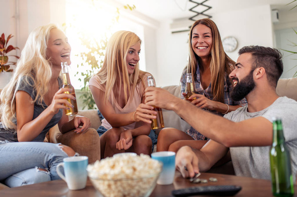 Friends watching football game at home,enjoying together. - Foto, Imagen