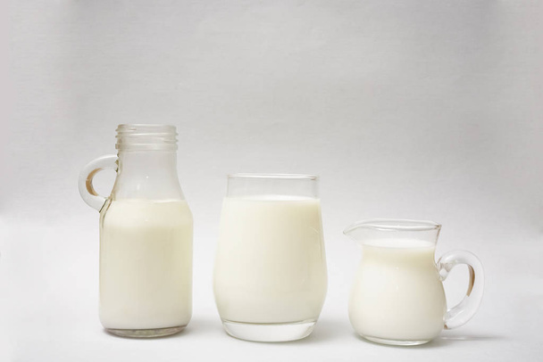 Milk bottle, jug and glass of milk isolated on  paper background - Fotografie, Obrázek