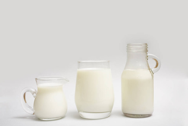 Milk bottle, jug and glass of milk isolated on  paper background - Foto, Imagem