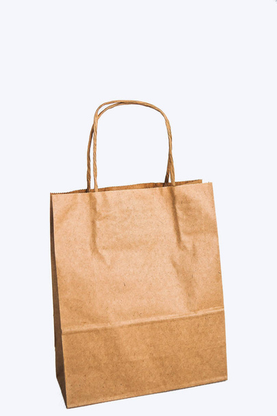 Kraft bags on a white background in a row - sale, shopping and gifts - Photo, Image