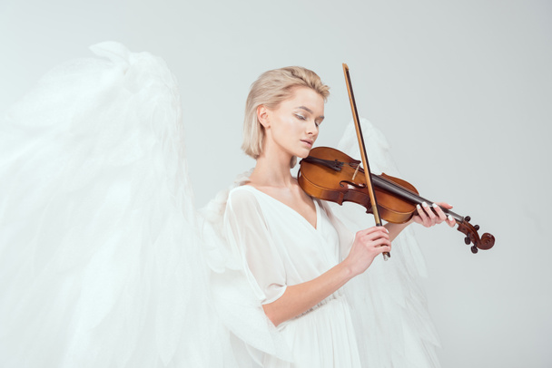beautiful woman in angel costume with wings playing violin isolated on white - Foto, imagen