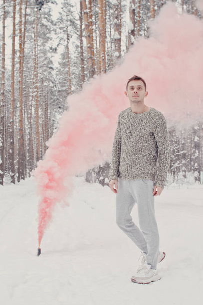 Temperature, freezing, cold snap. Bearded man smoking cigarette with skates in snowy forest. Man in thermal jacket, beard warm in winter. Winter sport, Christmas. skincare and beard care in winter. - Zdjęcie, obraz